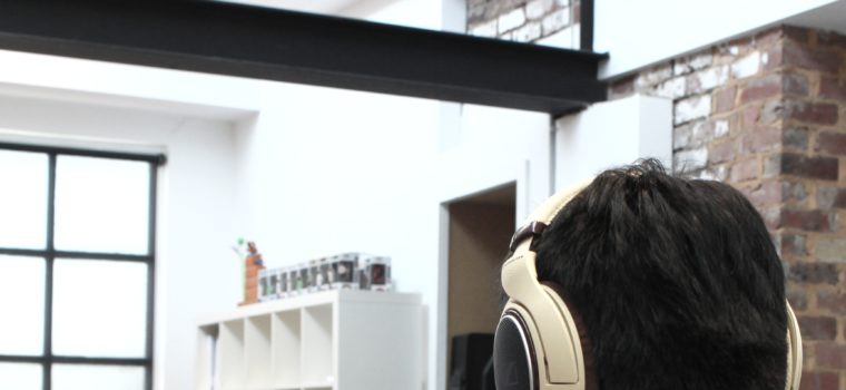 man wearing headphones while using computer